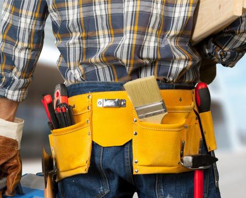 Handyman working on a property maintenance task outdoors.