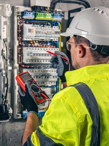 Electrician working on a switchboard panel.